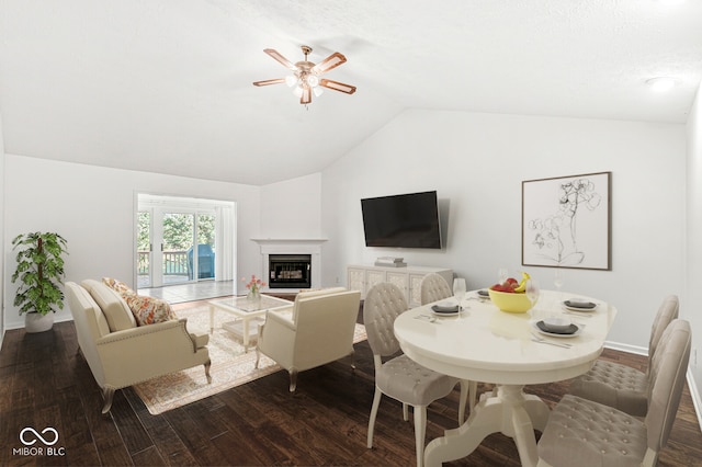 living room with vaulted ceiling, dark wood-type flooring, and ceiling fan