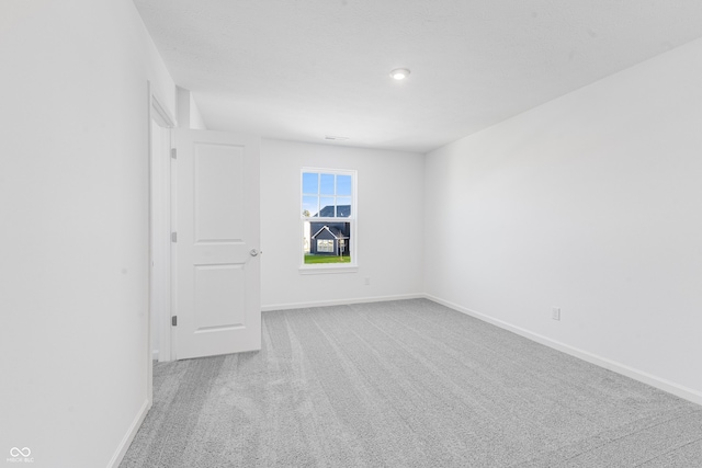 empty room with light colored carpet