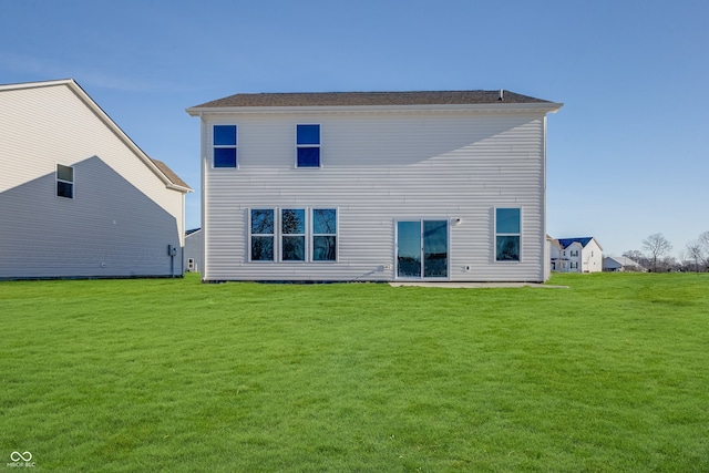 rear view of house featuring a yard