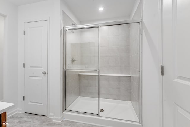 bathroom featuring vanity and a shower with shower door