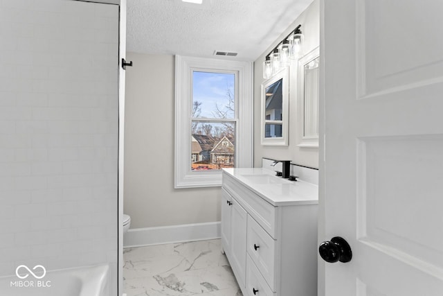 bathroom featuring visible vents, baseboards, vanity, marble finish floor, and a textured ceiling