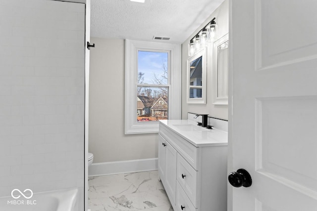 bathroom with visible vents, baseboards, vanity, marble finish floor, and a textured ceiling