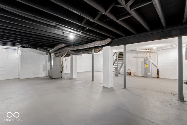 unfinished basement with water heater, heating unit, and stairs