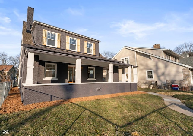 back of property featuring a yard, fence, covered porch, and a chimney