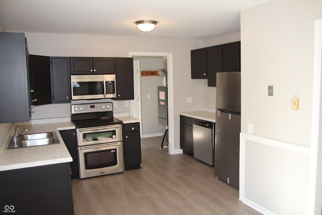 kitchen featuring light hardwood / wood-style flooring, stainless steel appliances, and sink