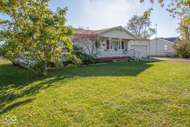 view of front of house featuring a front yard, covered porch, and a garage