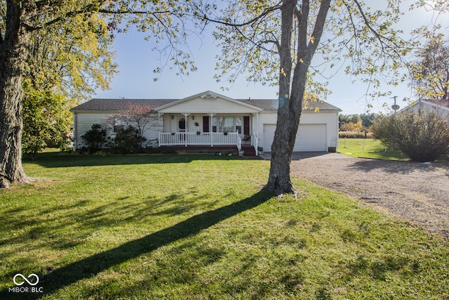 ranch-style house featuring a front yard, covered porch, and a garage