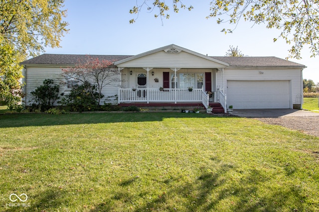 ranch-style home featuring covered porch, a front yard, and a garage