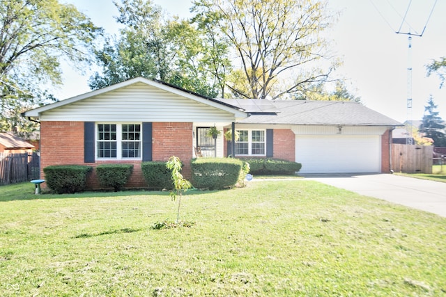 ranch-style home with an attached garage, solar panels, a front lawn, and concrete driveway