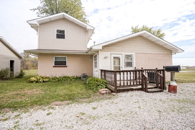 rear view of house with a wooden deck, a lawn, and central AC unit