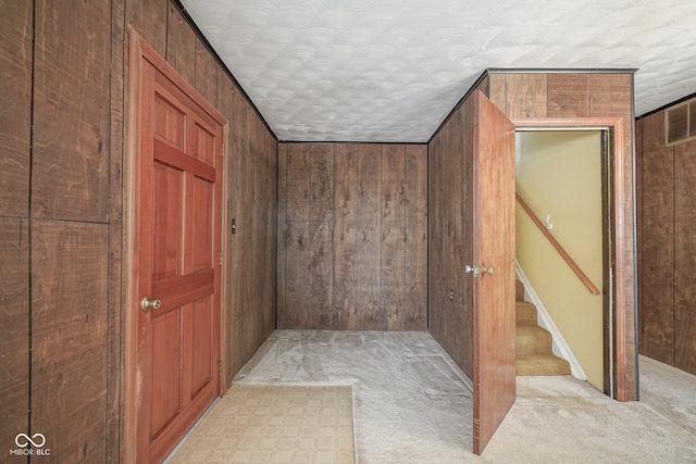 interior space with wood walls and a textured ceiling