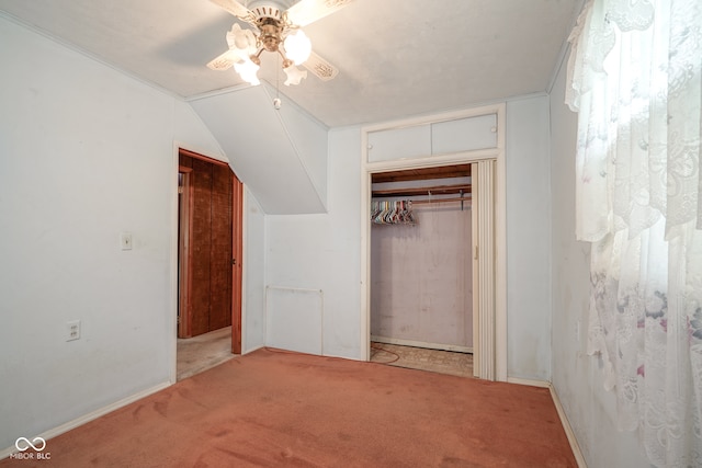 unfurnished bedroom featuring a closet, carpet flooring, lofted ceiling, and ceiling fan