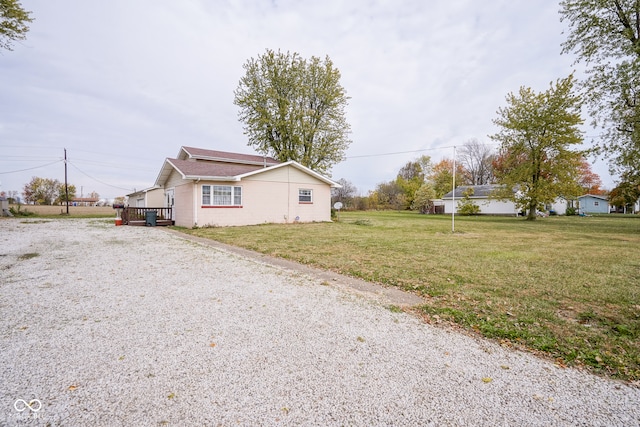 view of property exterior with a lawn