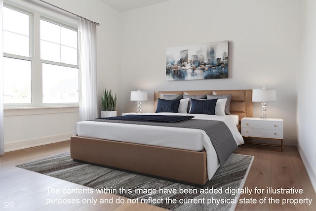 bedroom featuring baseboards and wood finished floors