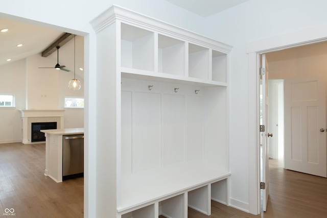 mudroom featuring a fireplace, recessed lighting, wood finished floors, and lofted ceiling