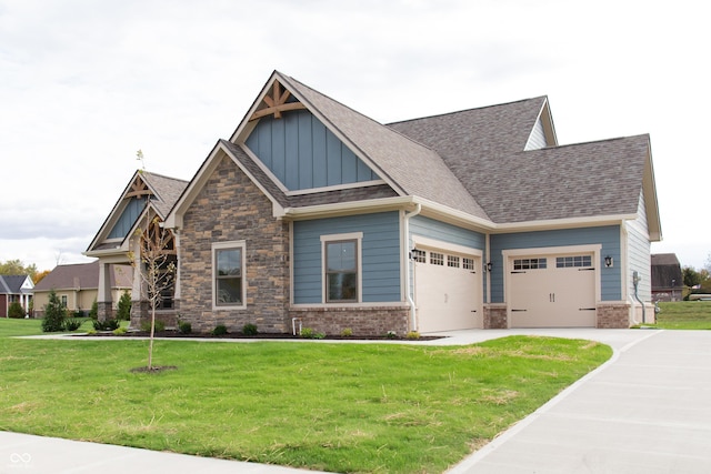 craftsman inspired home featuring board and batten siding, an attached garage, driveway, and a front lawn