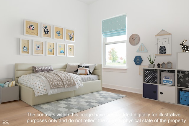 bedroom with baseboards and wood finished floors