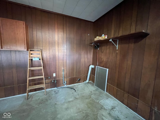 laundry room with wood walls