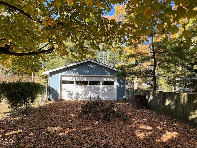 detached garage featuring fence