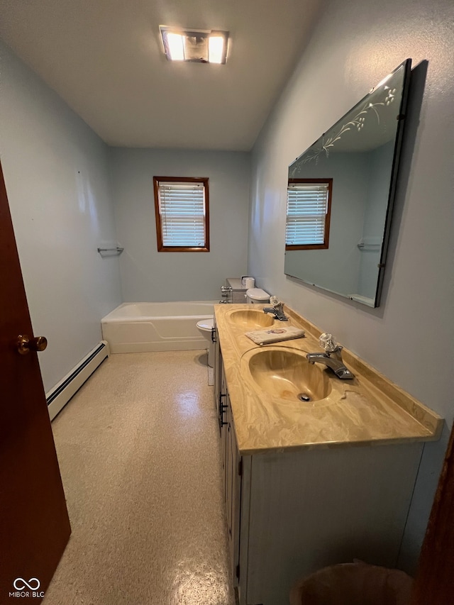 bathroom featuring toilet, a tub to relax in, vanity, and a baseboard radiator