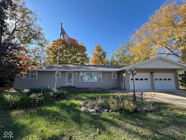 single story home featuring a front lawn and a garage