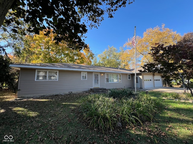 single story home featuring a garage and a front lawn