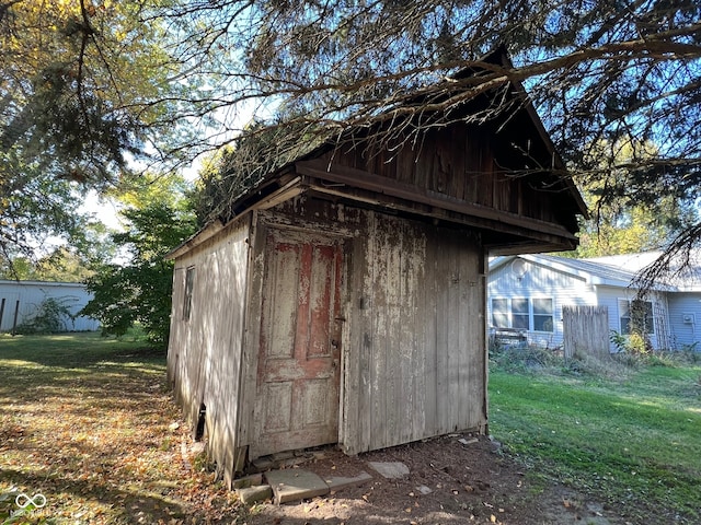 view of outdoor structure featuring a lawn