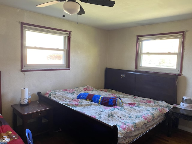 bedroom with a ceiling fan and wood finished floors