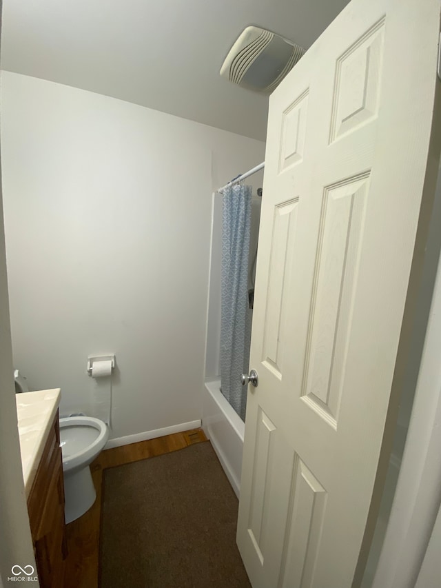 full bathroom featuring vanity, shower / bath combo, hardwood / wood-style flooring, and toilet