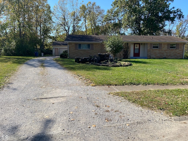 single story home featuring a front yard and a garage