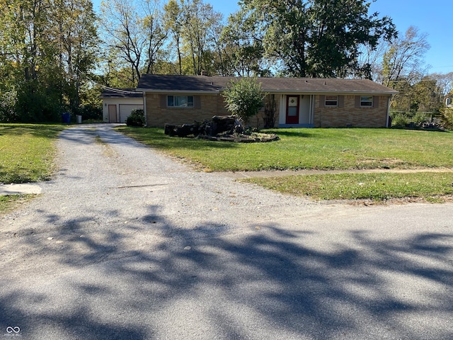 single story home featuring a front yard and a garage