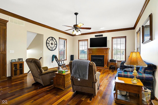 living room with ornamental molding, plenty of natural light, and dark hardwood / wood-style floors