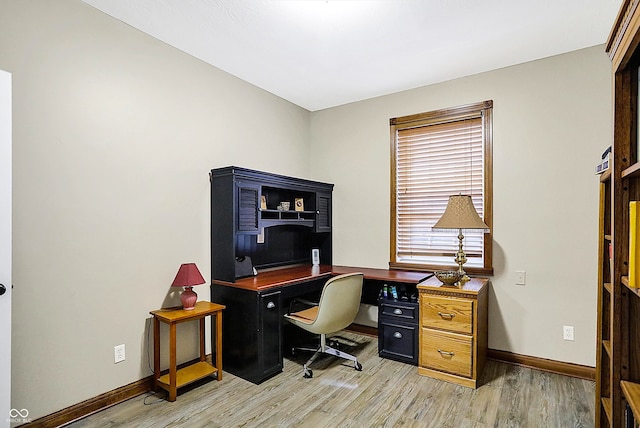 home office with light hardwood / wood-style floors