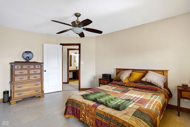 7178 Lockford N, Avon, IN 46123 - bedroom with visible vents, wood finished floors, baseboards, ceiling fan, and ensuite bath