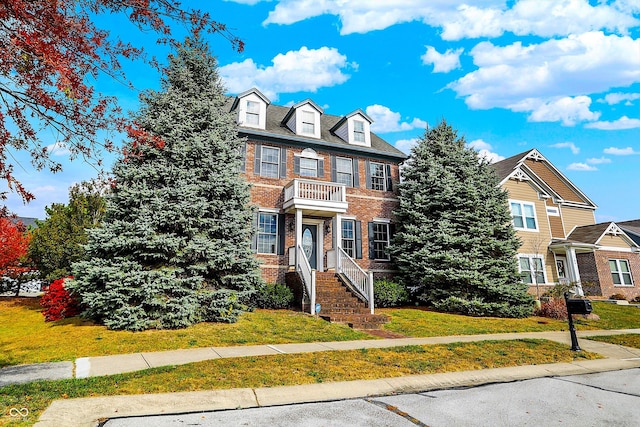 7178 Lockford N, Avon, IN 46123 - view of front facade featuring a balcony, a front yard, and brick siding