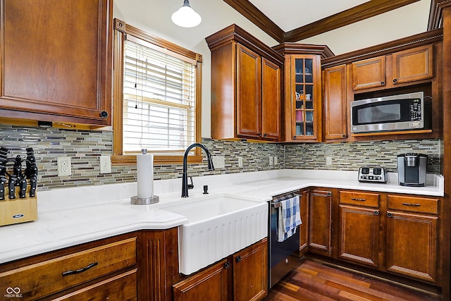 kitchen with sink, crown molding, appliances with stainless steel finishes, dark hardwood / wood-style flooring, and decorative backsplash