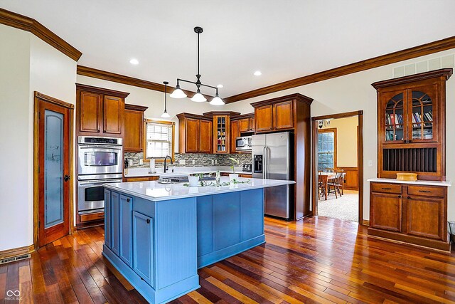 7178 Lockford N, Avon, IN 46123 - kitchen featuring crown molding, appliances with stainless steel finishes, dark wood finished floors, a center island, and visible vents