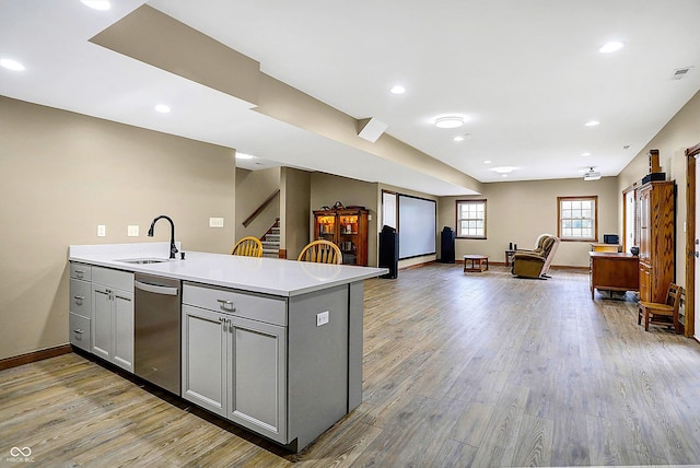 7178 Lockford N, Avon, IN 46123 - kitchen featuring a sink, light countertops, light wood-style flooring, stainless steel dishwasher, and gray cabinetry