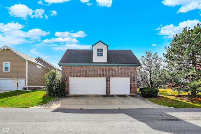 view of front of property featuring a garage and a front lawn