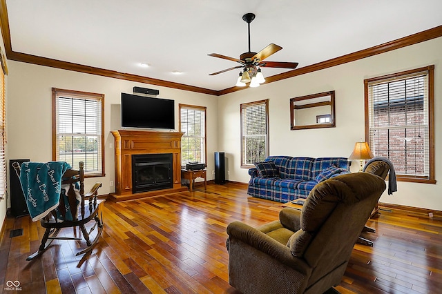 living room featuring crown molding, hardwood / wood-style flooring, and a wealth of natural light