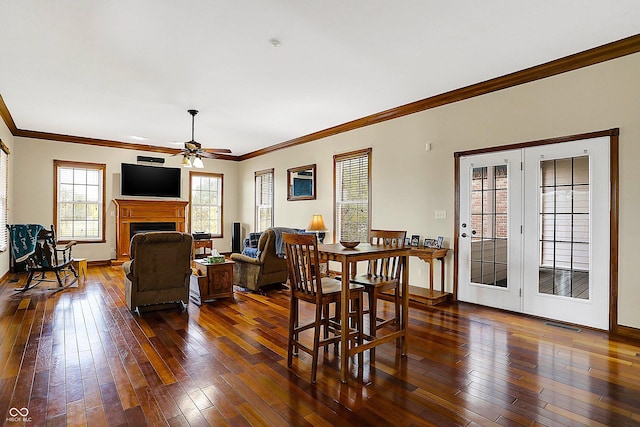 7178 Lockford N, Avon, IN 46123 - dining room featuring crown molding, ceiling fan, a fireplace, and dark wood-type flooring