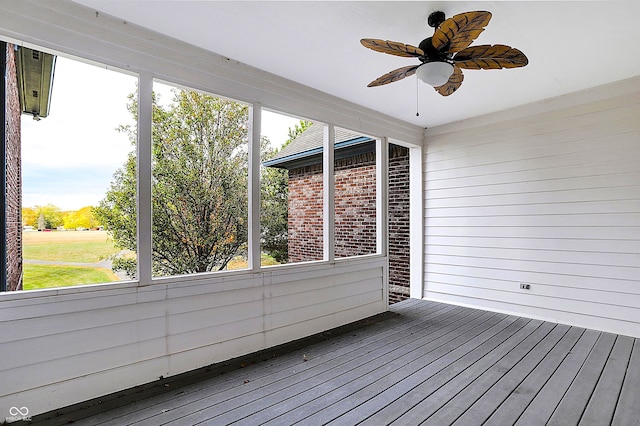 unfurnished sunroom featuring ceiling fan