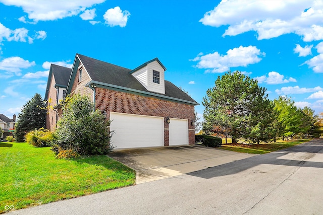 view of side of property featuring a garage and a yard