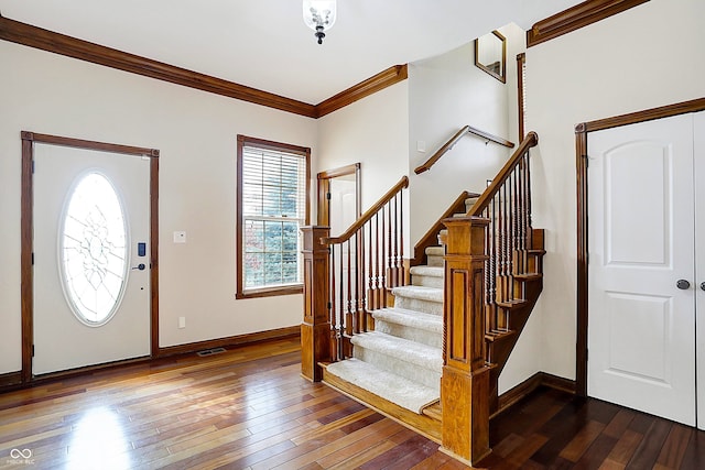 foyer featuring dark hardwood / wood-style flooring and ornamental molding