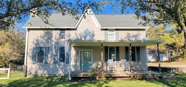 view of front of property with covered porch and a front lawn