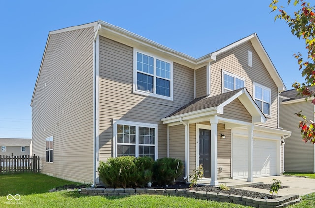 view of front of home with a garage and a front lawn