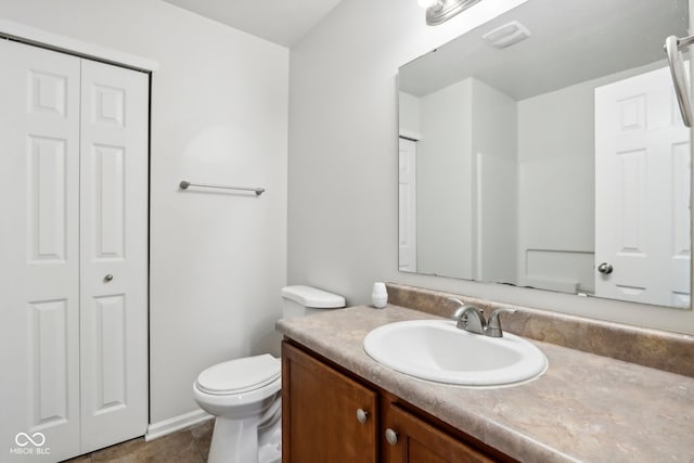 bathroom featuring vanity, toilet, and tile patterned flooring