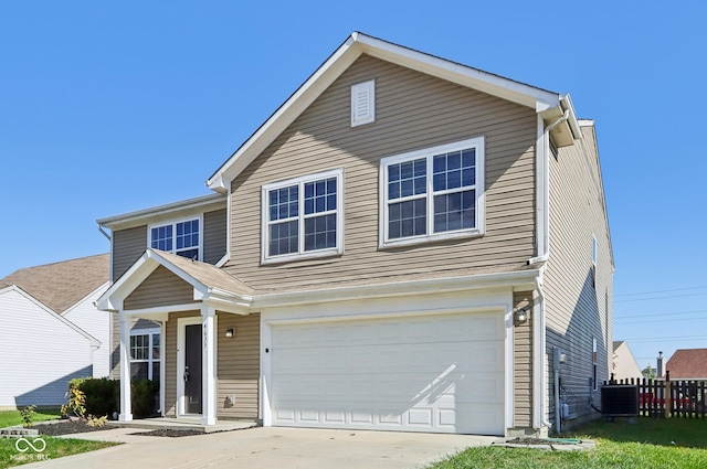 view of property featuring a garage and cooling unit