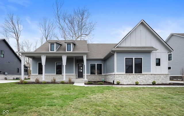 view of front of home with stone siding, board and batten siding, a porch, and a front yard