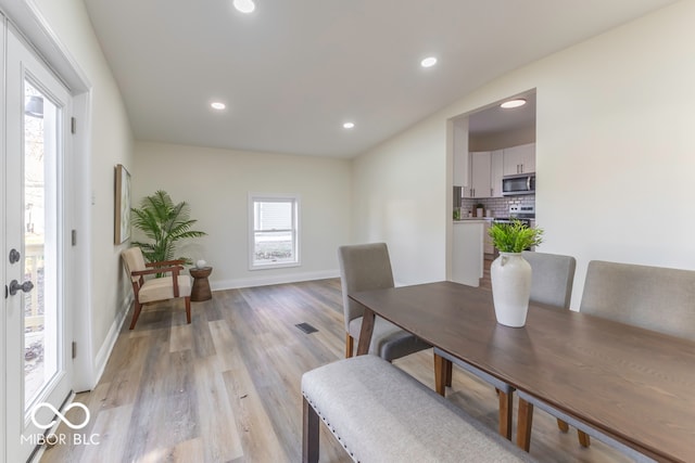 dining space with light hardwood / wood-style floors